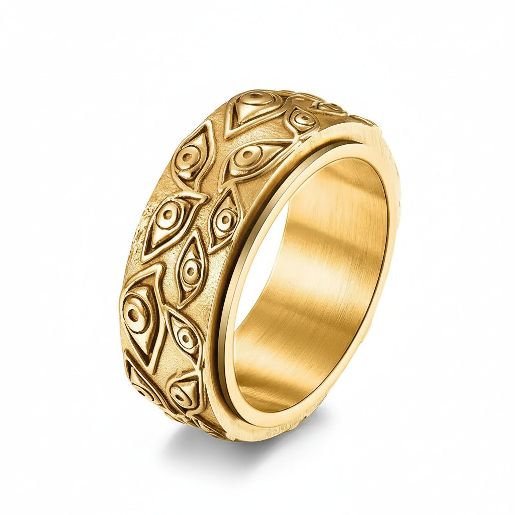 Gold ring with intricate patterns on a white background