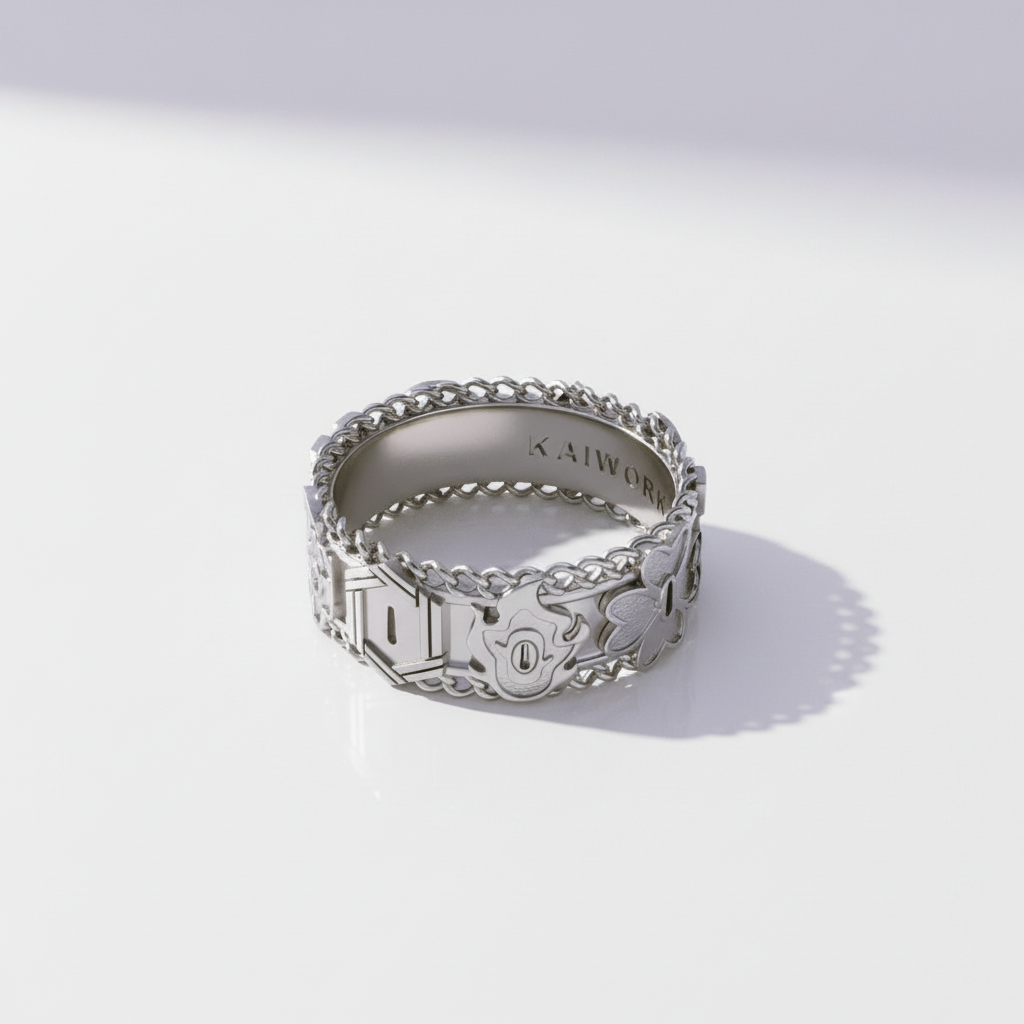 Silver ring with intricate designs on a light gray background