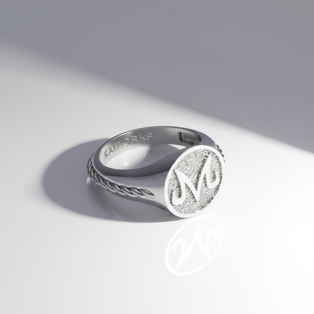 Silver ring with engraved design on a light gray background