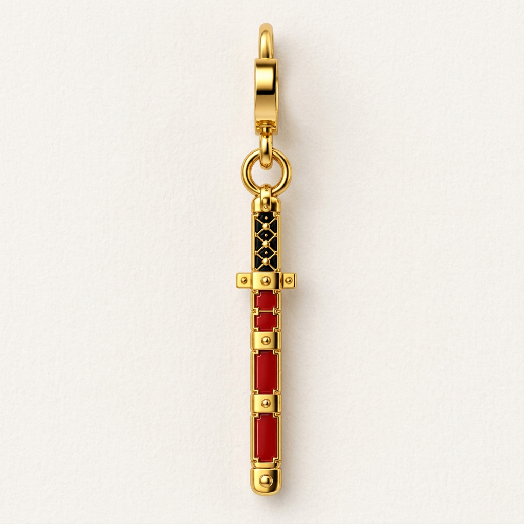 A gold-tone miniature sword charm with red and black enamel details, shown vertically against a clean white background.