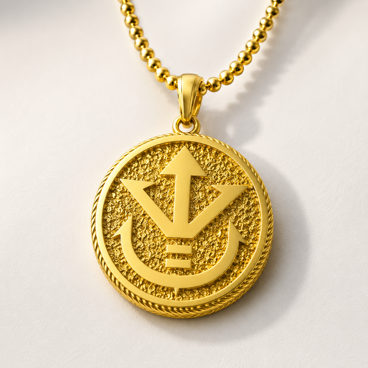 A round 14K gold pendant featuring a detailed embossed design of a royal crest, attached to a gold chain against a dark textured background.