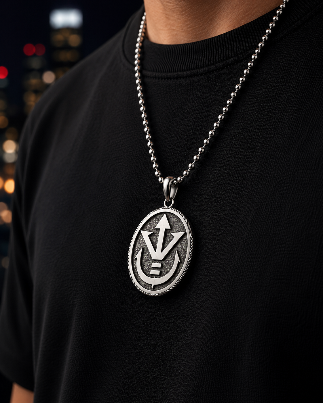 Person wearing a black shirt with a silver necklace featuring a detailed pendant.