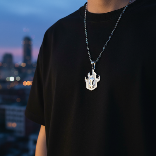 Person wearing a black t-shirt with a silver necklace featuring a unique pendant against a cityscape background.