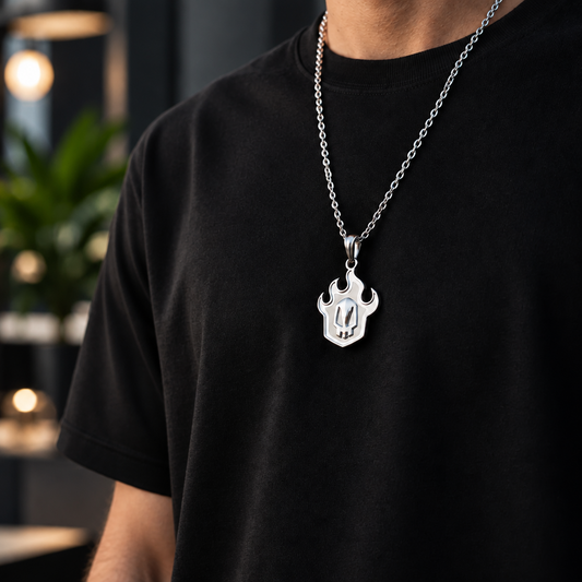 Person wearing a black t-shirt with a silver necklace featuring a unique pendant against a cityscape background.