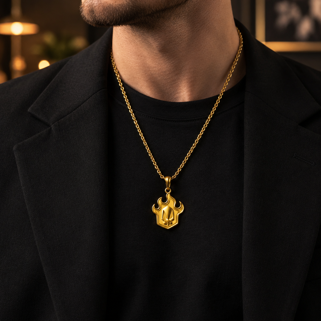 Person wearing a black t-shirt with a gold necklace featuring a pendant.