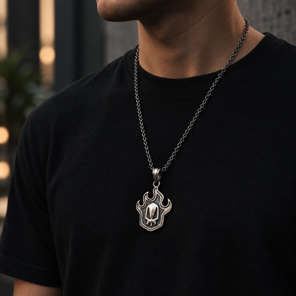 Person wearing a black t-shirt with a silver necklace featuring a paw print pendant on an urban street background.