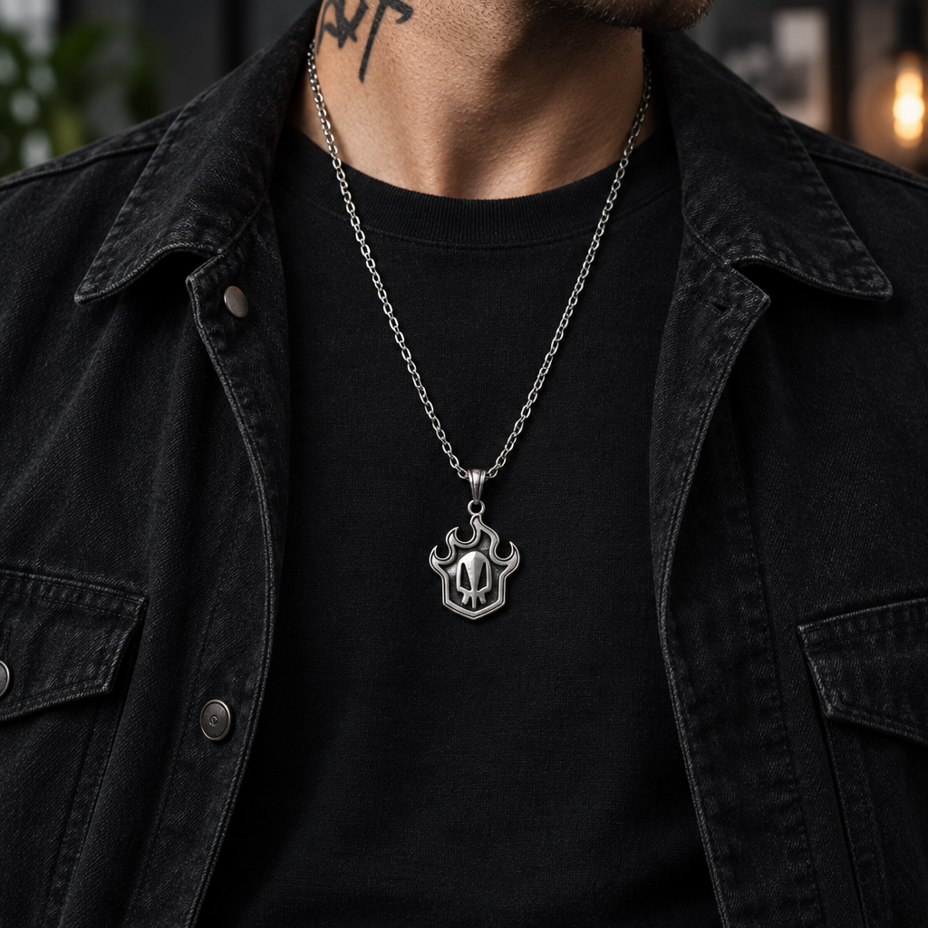 Person wearing a black t-shirt with a silver necklace in an urban night setting