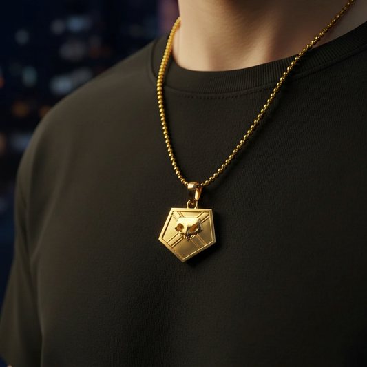 Gold necklace with a hexagonal pendant on a black shirt against a blurred background