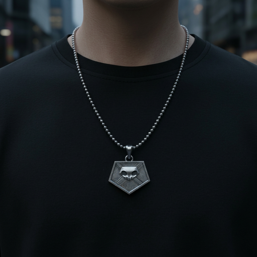 Person wearing a silver necklace with a geometric pendant on a blurred background