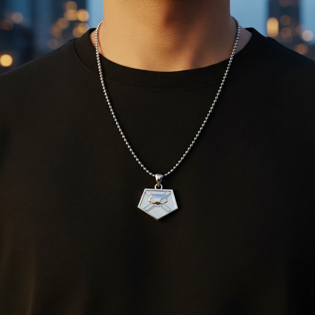 Person wearing a black shirt with a silver necklace featuring a geometric pendant.