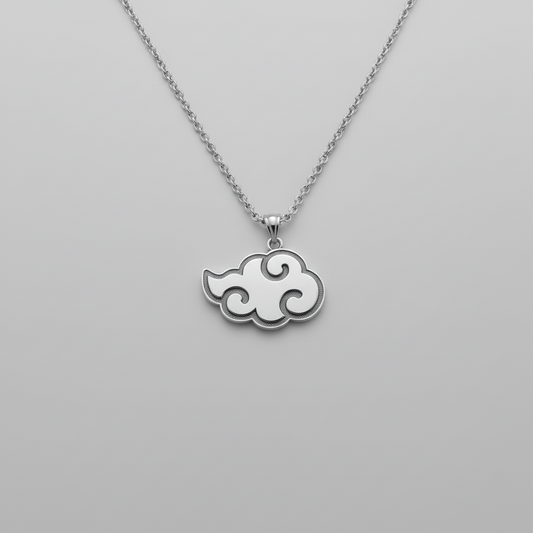 Cloud-shaped pendant on a chain resting on a dark stone surface with smoke effect.
