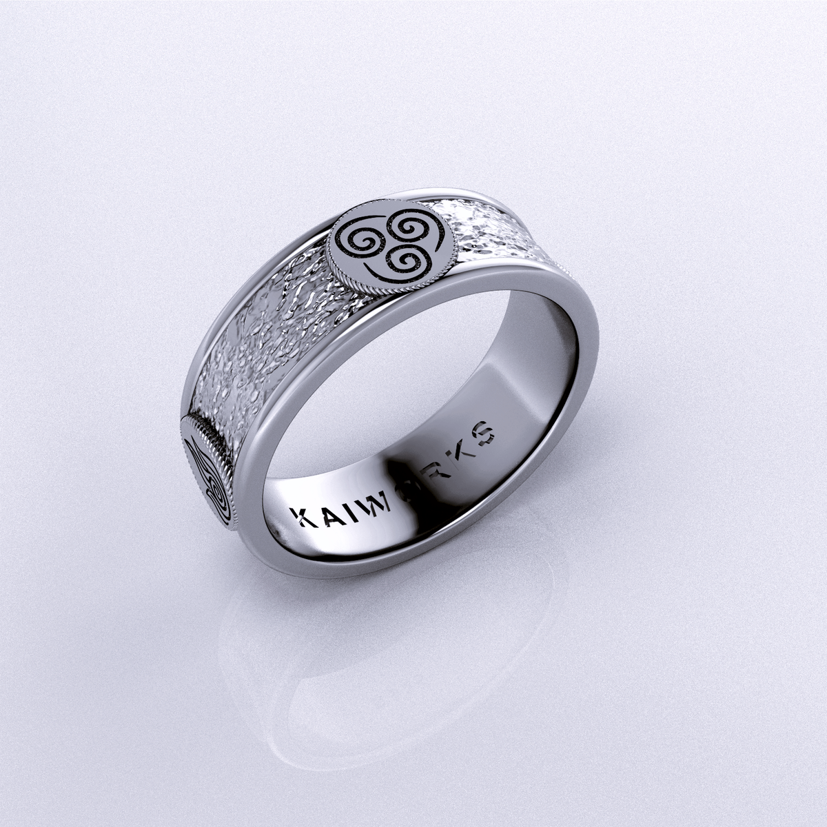 Four Nations Ring featuring a textured design and a symbol, crafted in sterling silver for elemental balance.