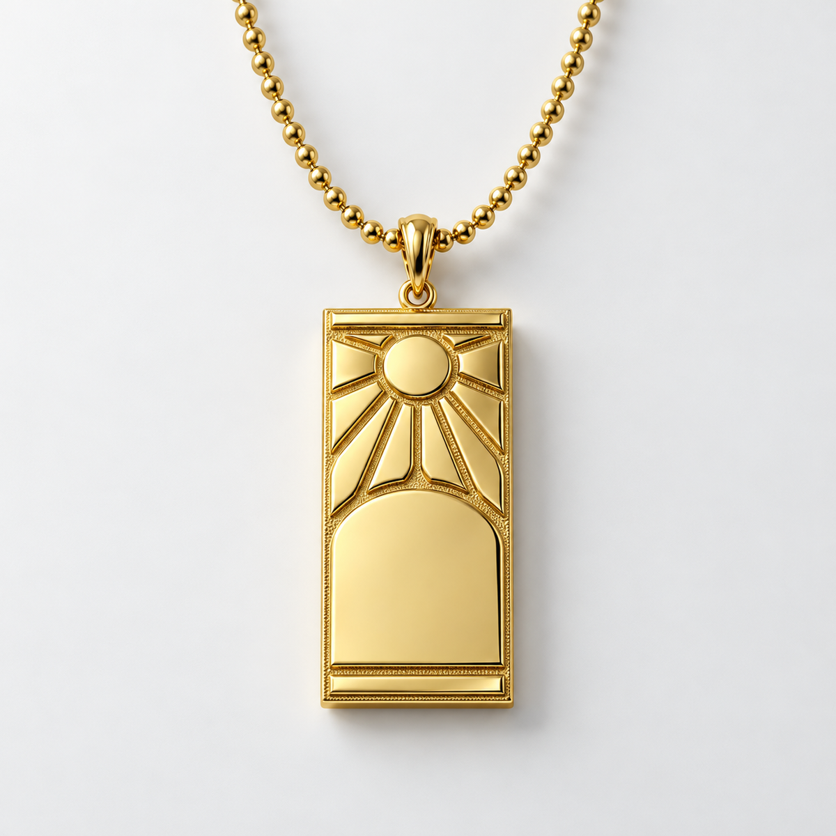 Gold pendant with sun design on a white background
