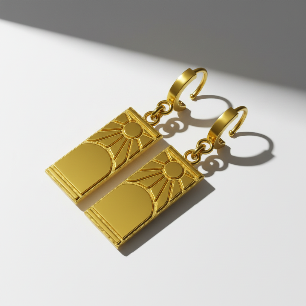 A pair of 14K gold Hanafuda earrings featuring a sun motif, placed on a wooden surface with leaves in the background.