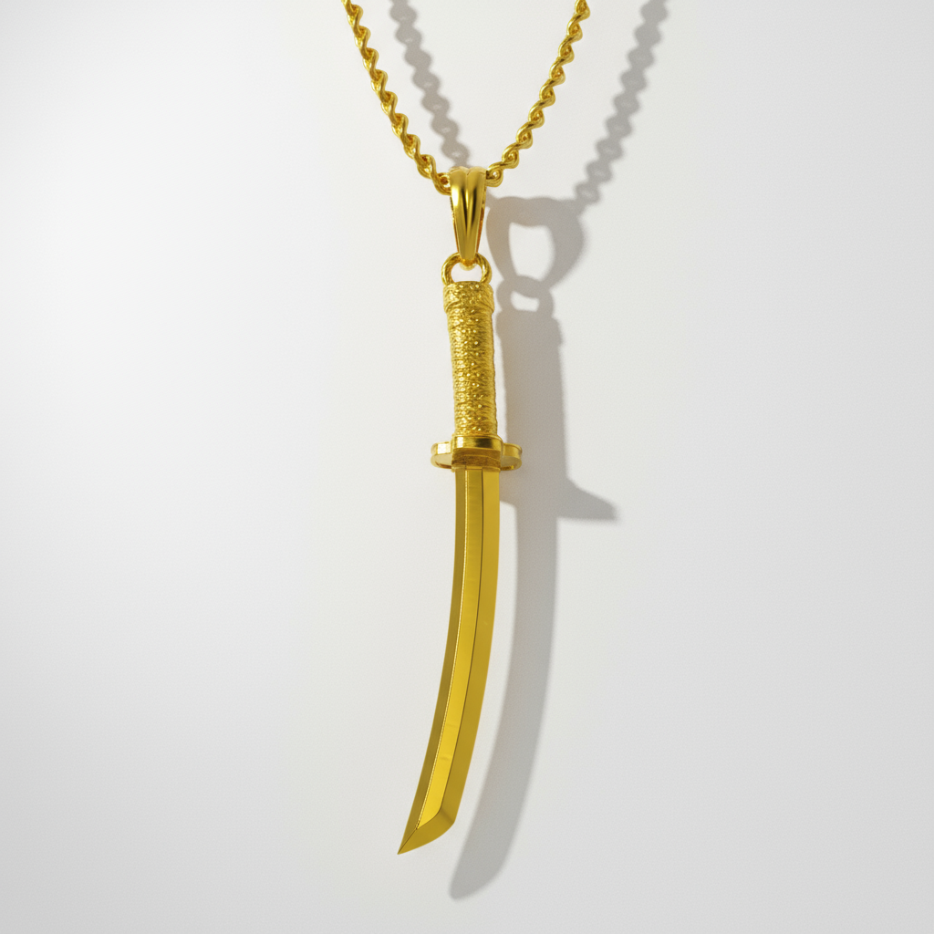 A 14K gold pendant in the shape of a traditional Japanese katana sword, displayed against a wooden background with a plant and a rock in the backdrop.