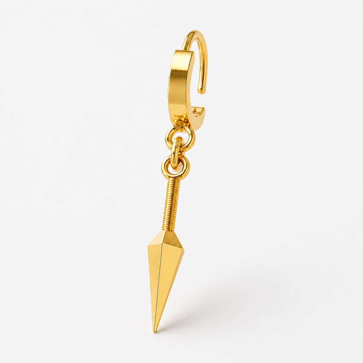 A pair of 14K gold kunai earrings with a polished silver and 18K yellow gold plating, displayed on a wooden surface with a plant in the background.