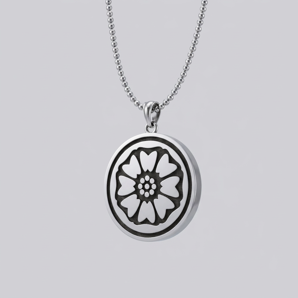 Silver necklace with a round pendant featuring a floral design on a white background
