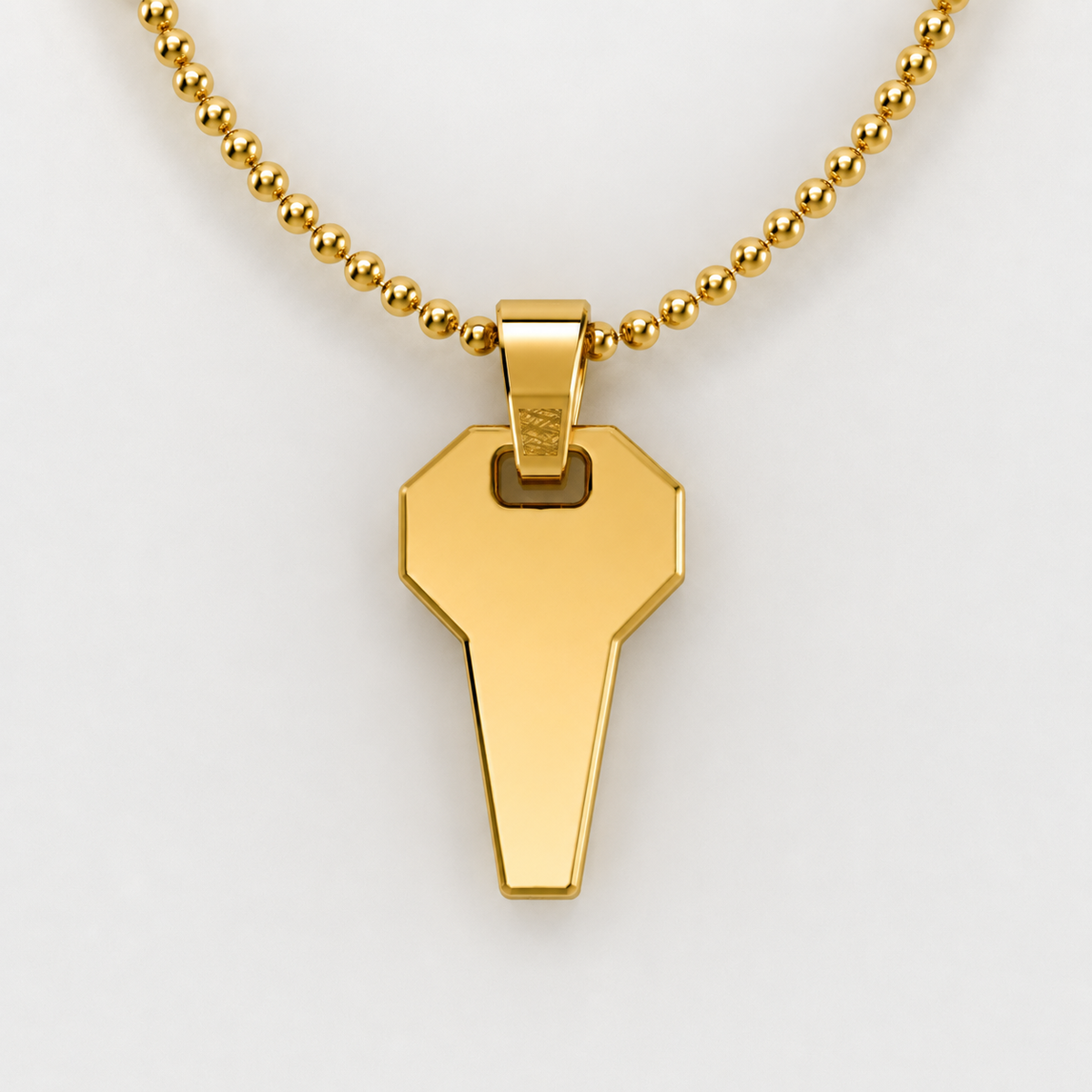 David Martinez Pendant in 14K Gold on a bead necklace, showcasing its unique key design.