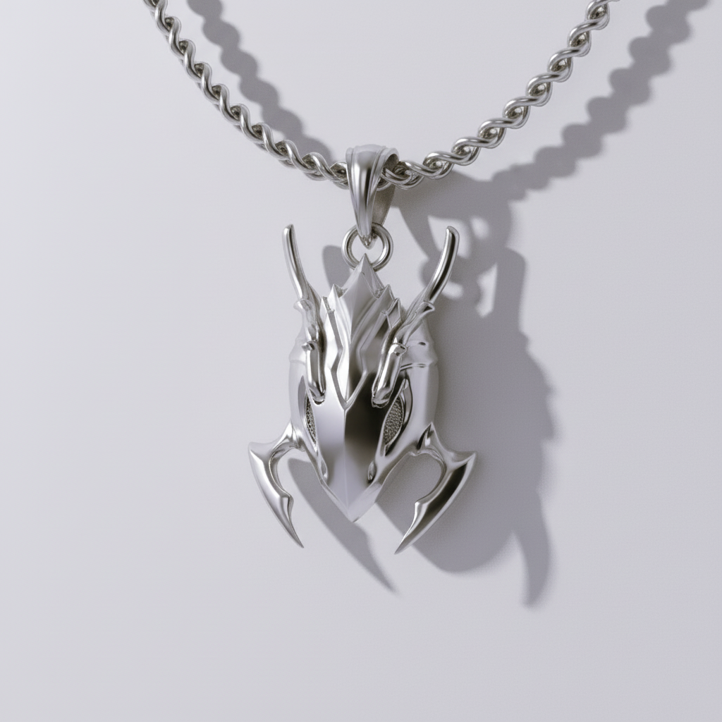 A silver pendant with a dark, rugged design, featuring intricate details and a glossy finish, displayed against a blue and black patterned background.