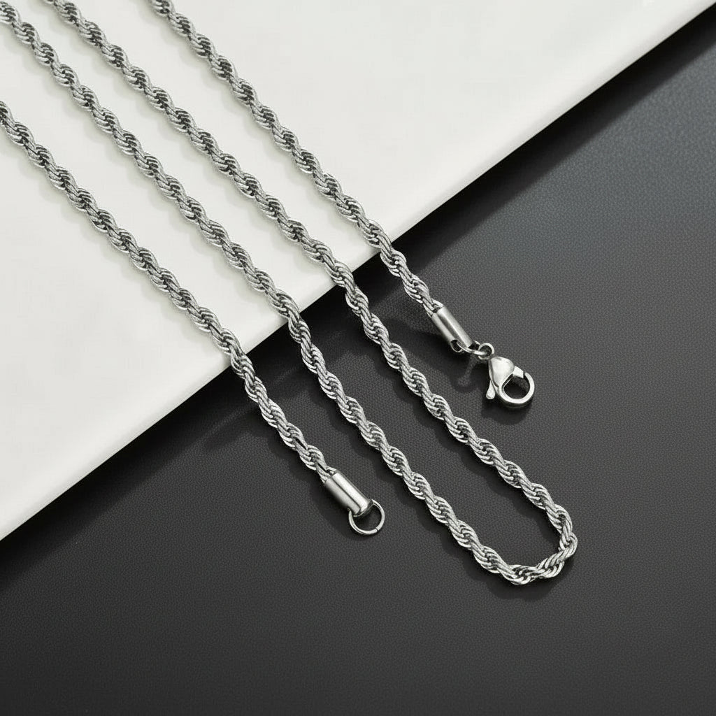 Silver rope chain necklace on a black and white background
