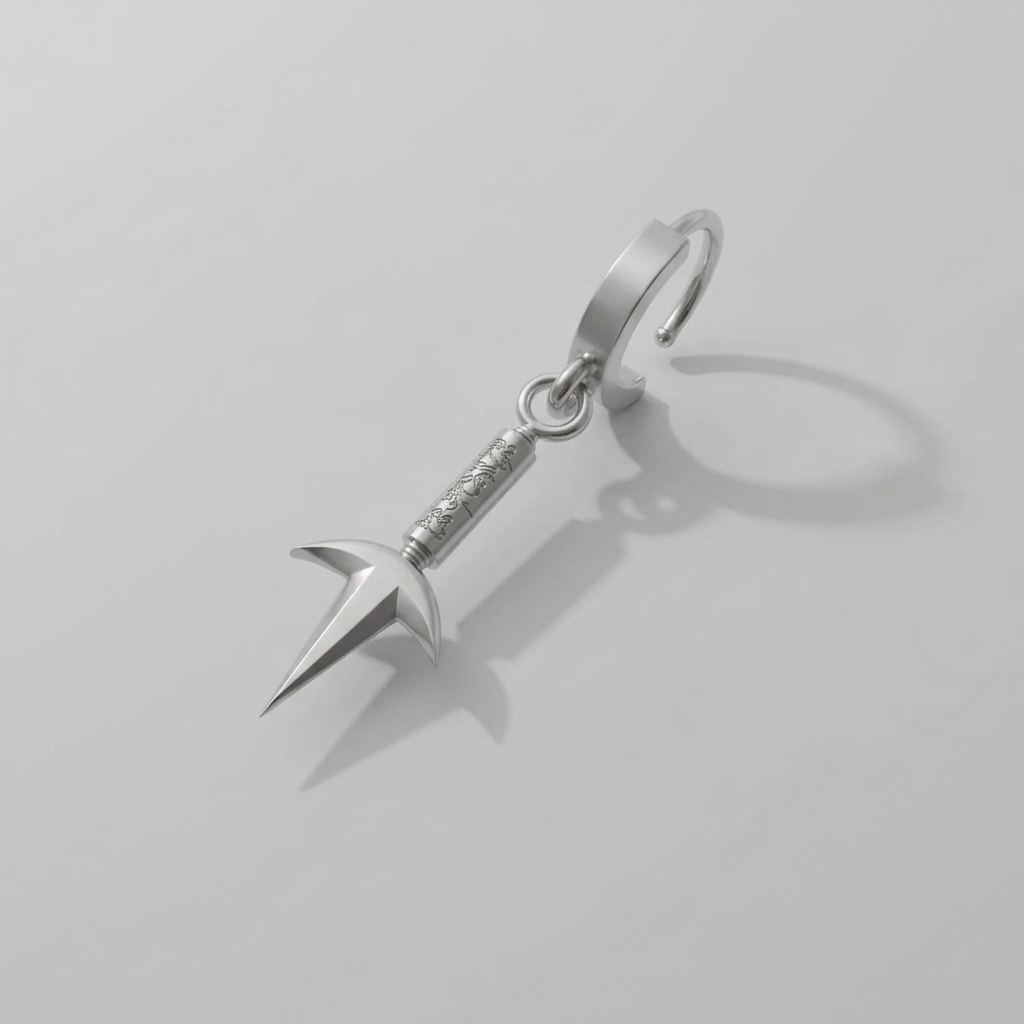 Silver keychain with a unique design on a light gray background