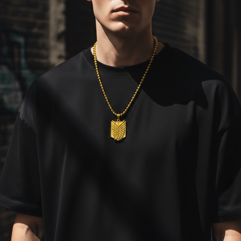 Person wearing a black shirt with a gold necklace featuring a pendant.