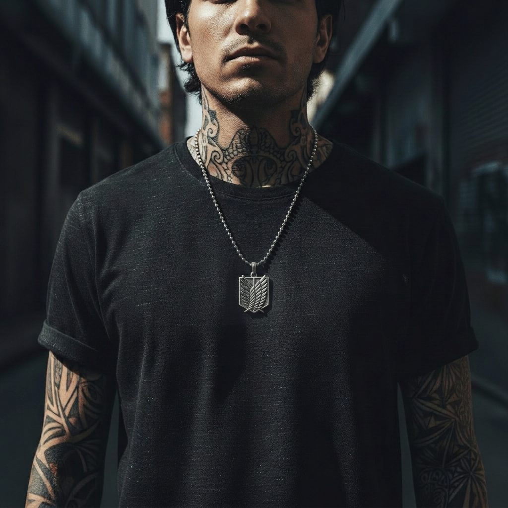 Man with tattoos wearing a black t-shirt and necklace in an urban setting