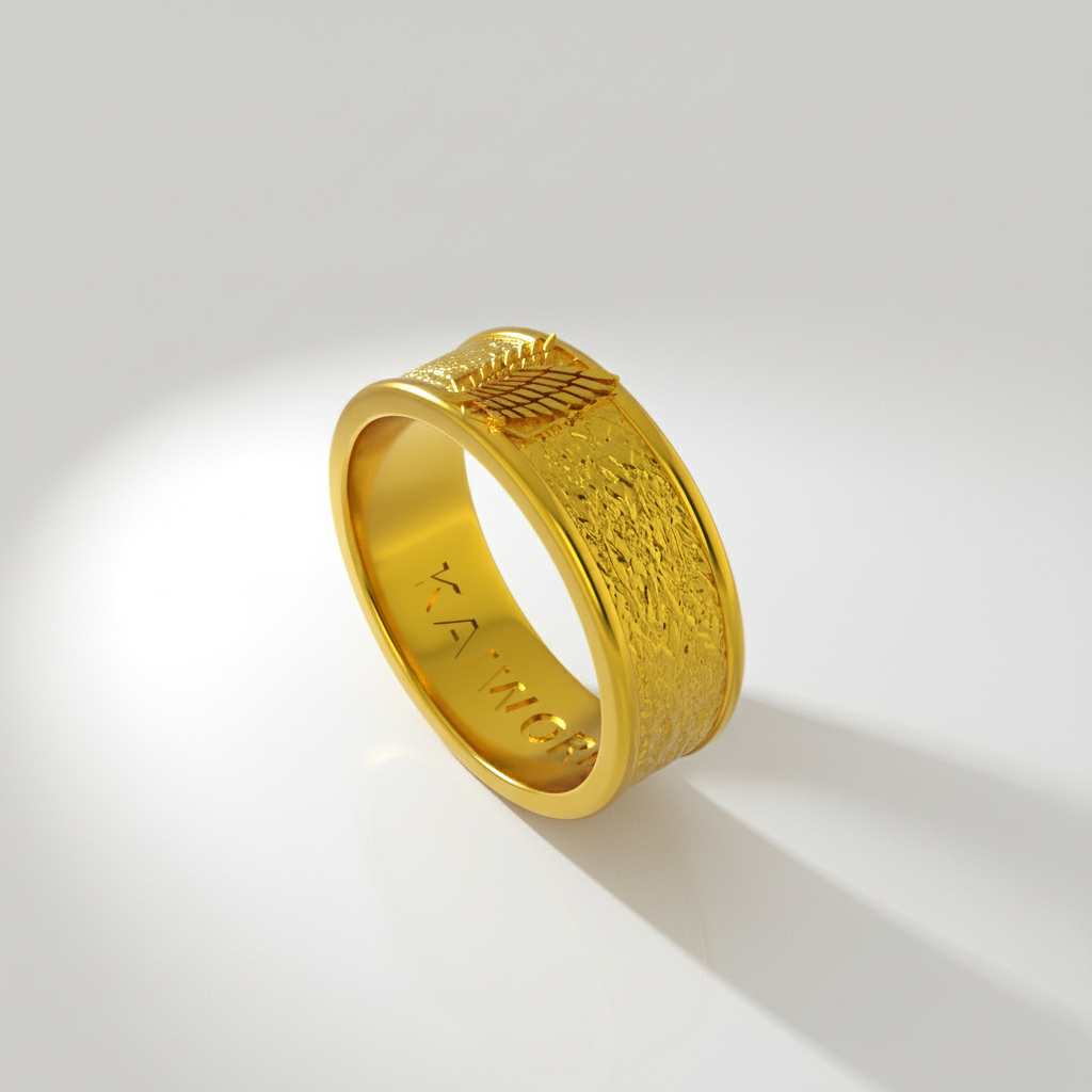 A silver ring with detailed wing design, set against a textured background featuring a silhouette of a character and the word 'ATTACK'.