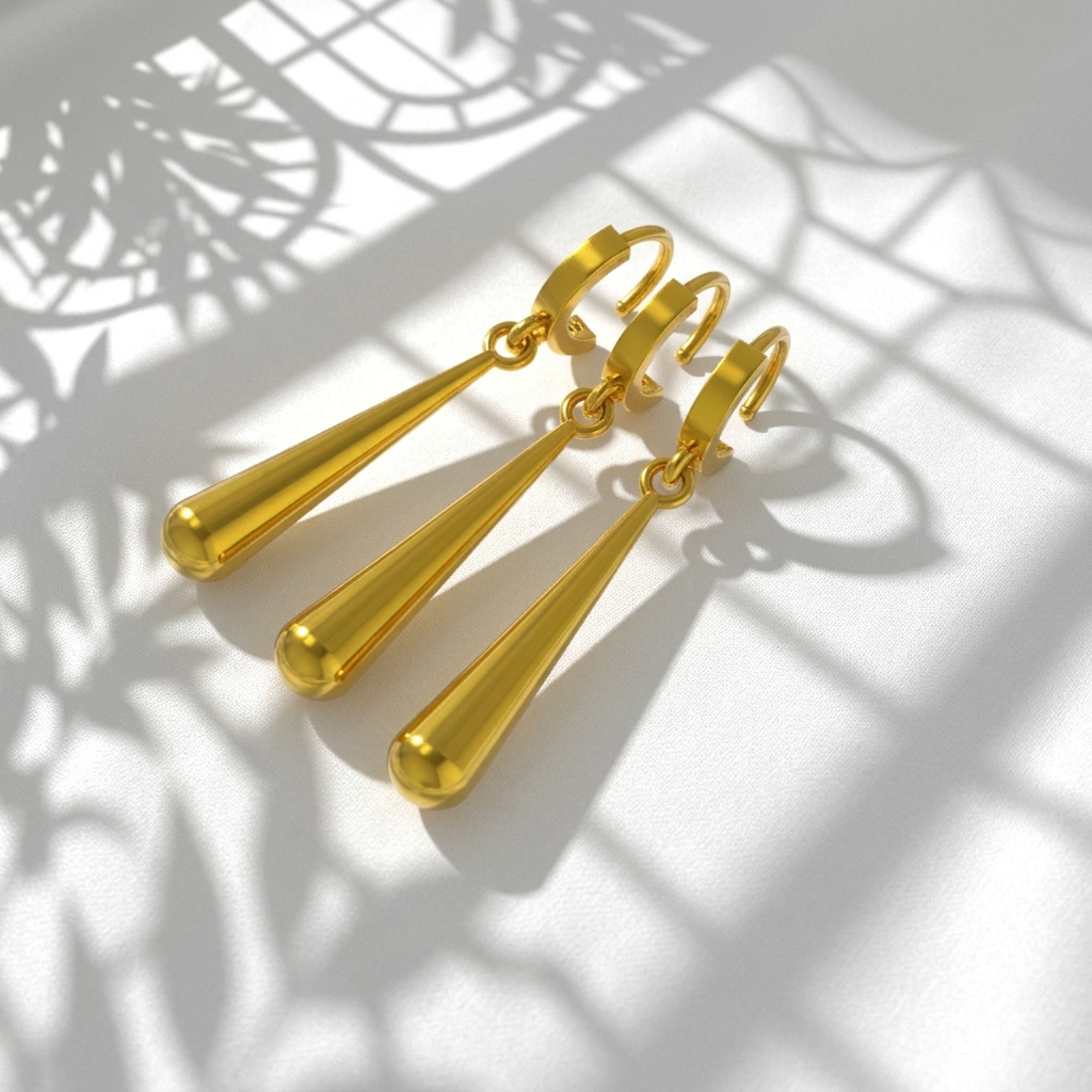 A set of three gold-colored earrings with a sword motif, placed on a wooden surface.