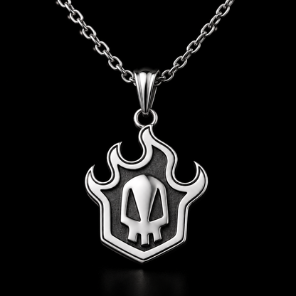 A silver pendant necklace with a flame-shaped outline and a skull design in the center, displayed inside a black jewelry box with the brand name KAIWORKS visible on the inside lid.