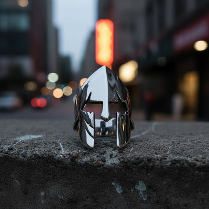 Metallic helmet-shaped object on a textured gray background