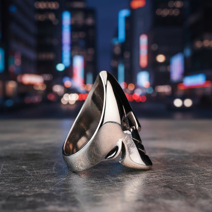 Silver ring with a unique design on a textured gray background