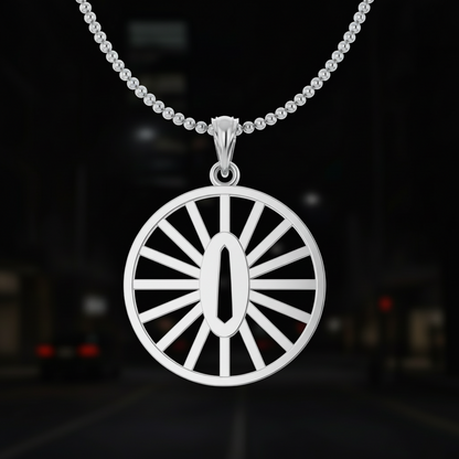 Gold pendant with a sunburst design on a dark background