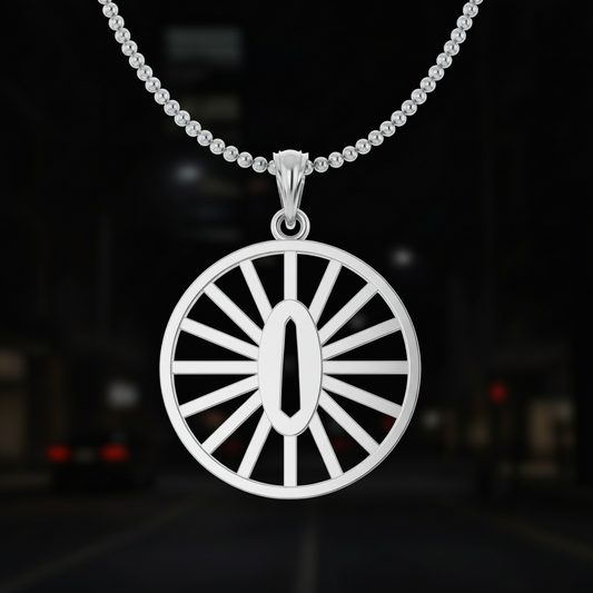 Gold pendant with a sunburst design on a dark background