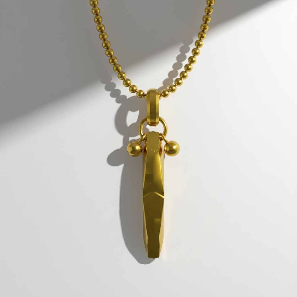 Gold whistle pendant on a chain against a white background
