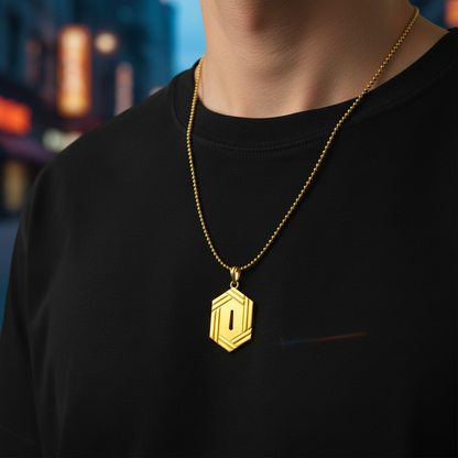 Person wearing a gold necklace with a hexagonal pendant against a blurred cityscape background