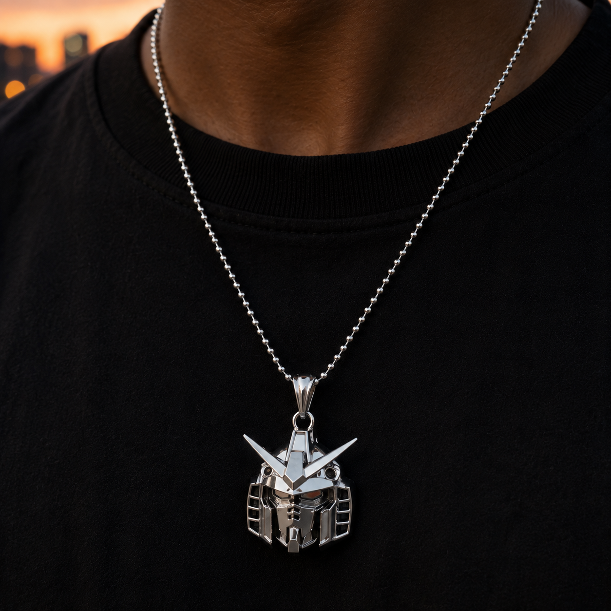 Silver pendant necklace on a black shirt with a blurred cityscape background