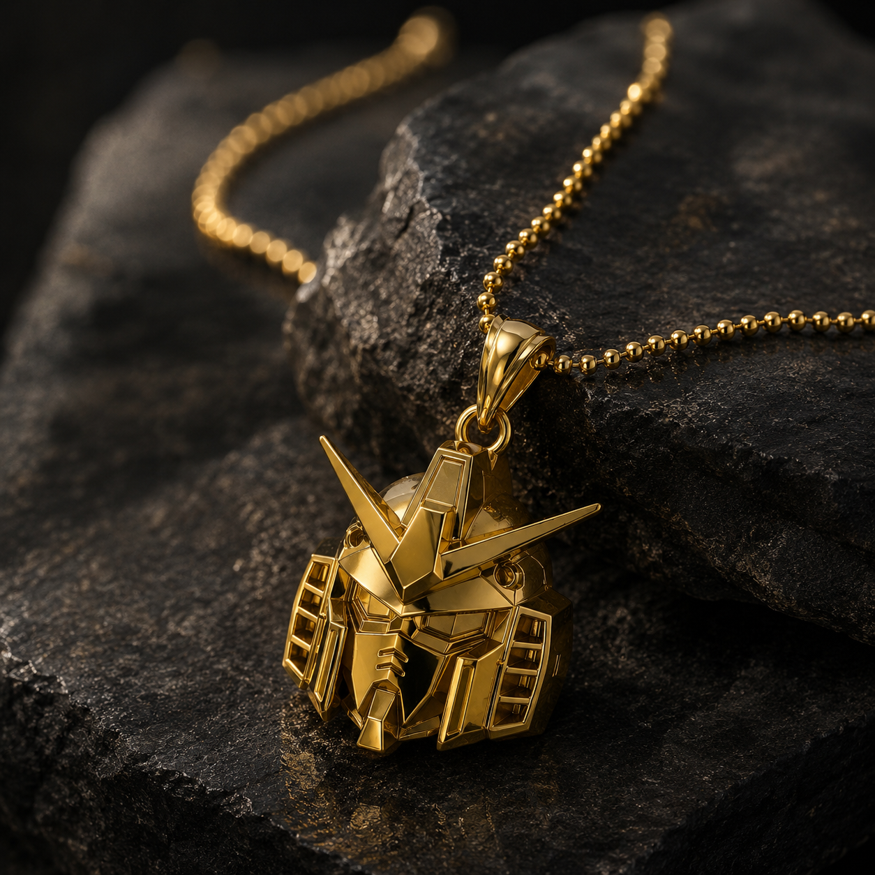 Gold robot pendant necklace on a dark stone surface