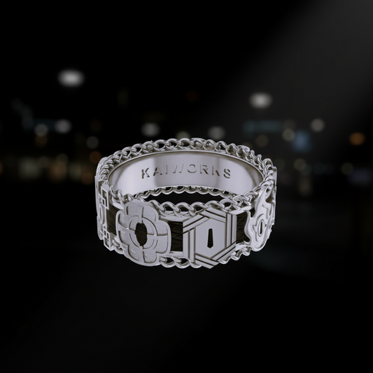 Silver ring with intricate design on a white background