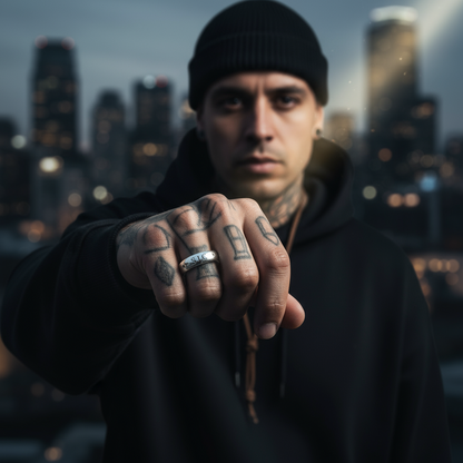 Man with tattoos on his hand in a cityscape