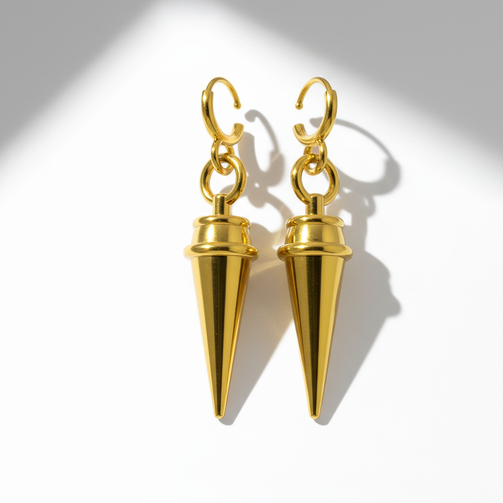 A pair of yellow gold hoop design earrings against a dark background featuring anime-style character illustrations.