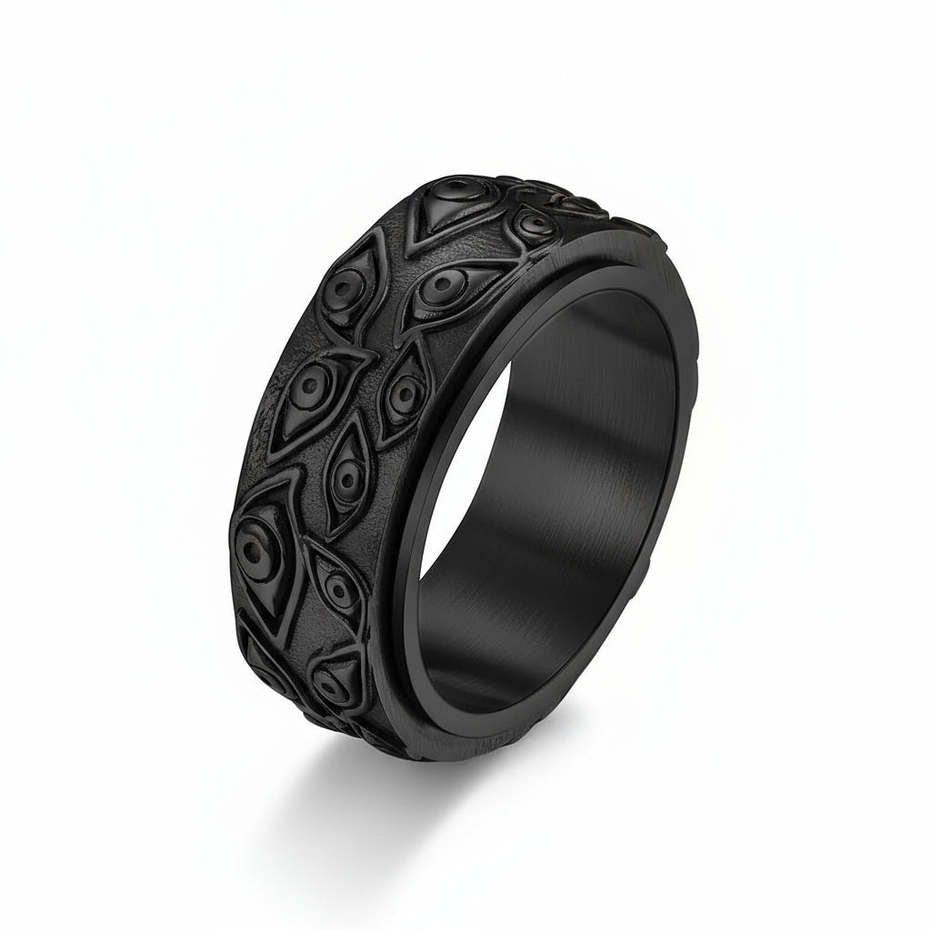 Black metal ring with intricate design on a white background
