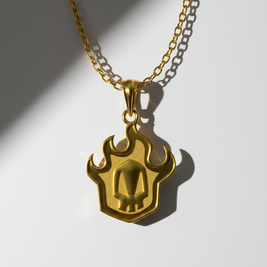 Gold pendant with flame design on a white background