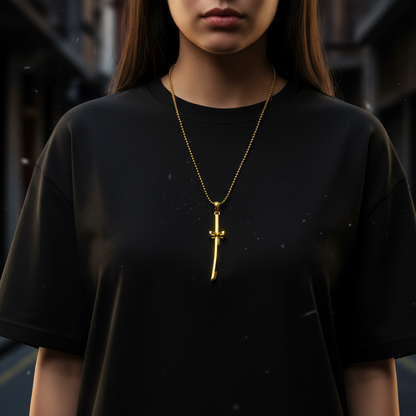 Person wearing a black t-shirt with a gold necklace featuring a cross pendant.