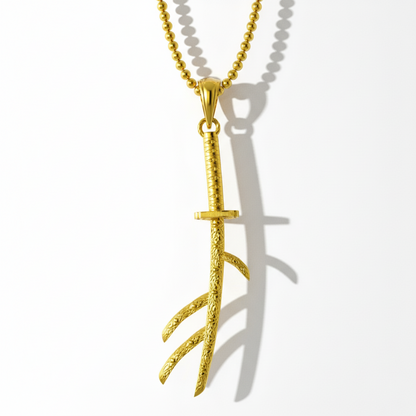 Gold branch-shaped pendant on a white background