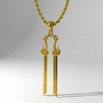 Gold sword-shaped pendant on a chain against a white background