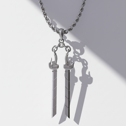 Silver sword-shaped pendant on a chain against a white background