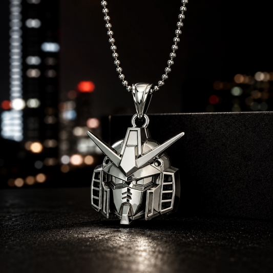 Metallic pendant shaped like a robot helmet on a chain against a blurred cityscape background