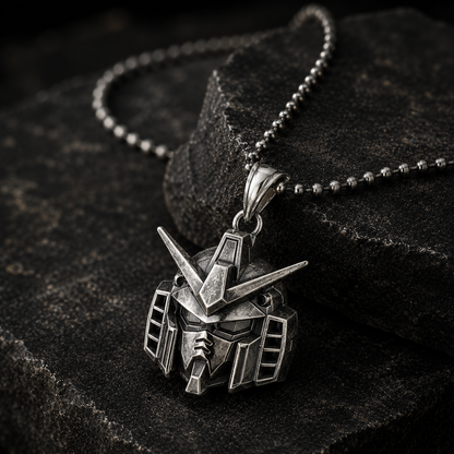 Silver robot pendant necklace on a dark stone surface