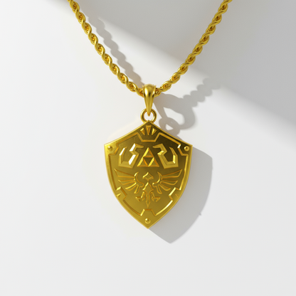Gold necklace with a shield-shaped pendant on a white background